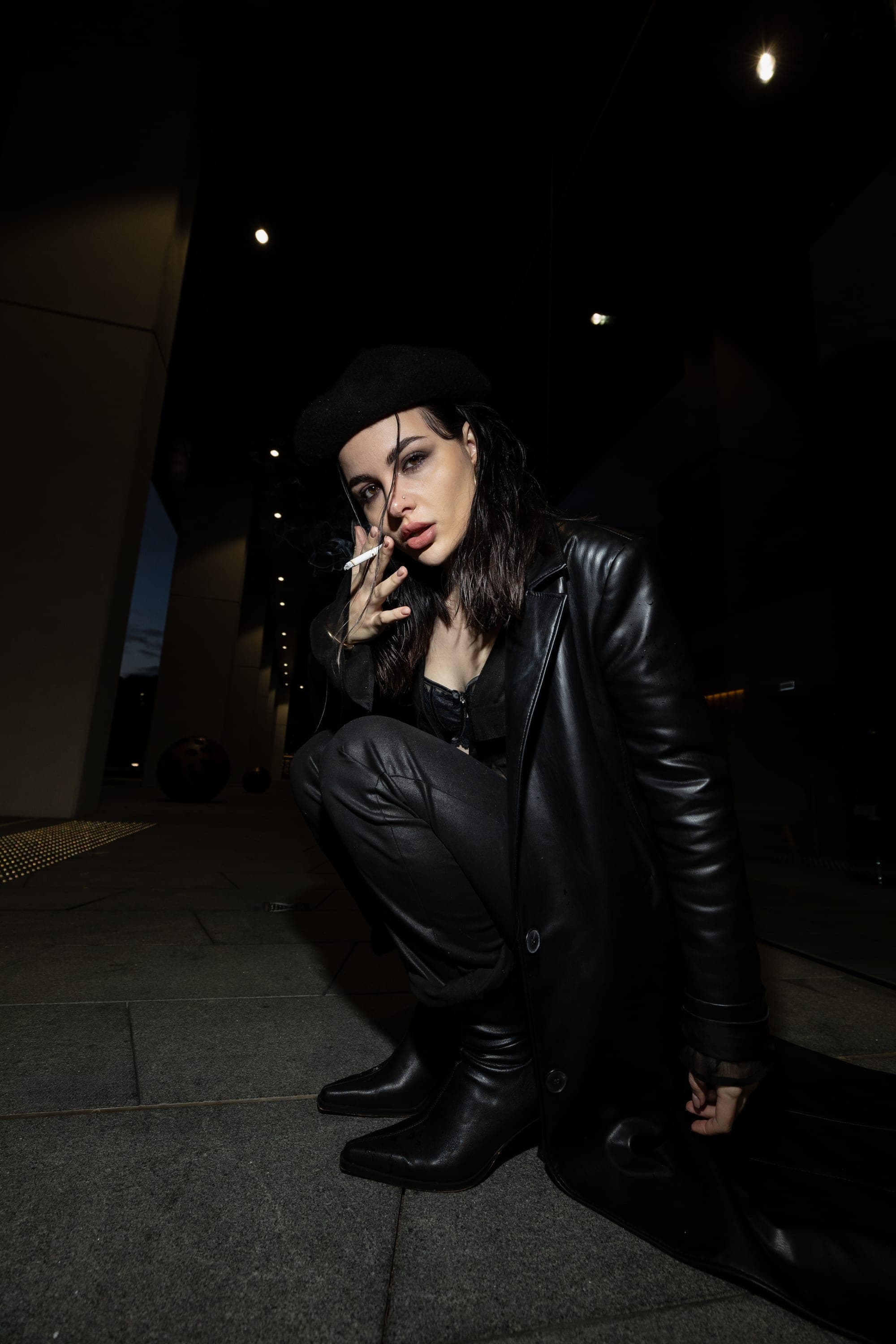 Model in a leather coat and beret smoking at night, Sydney street style editorial