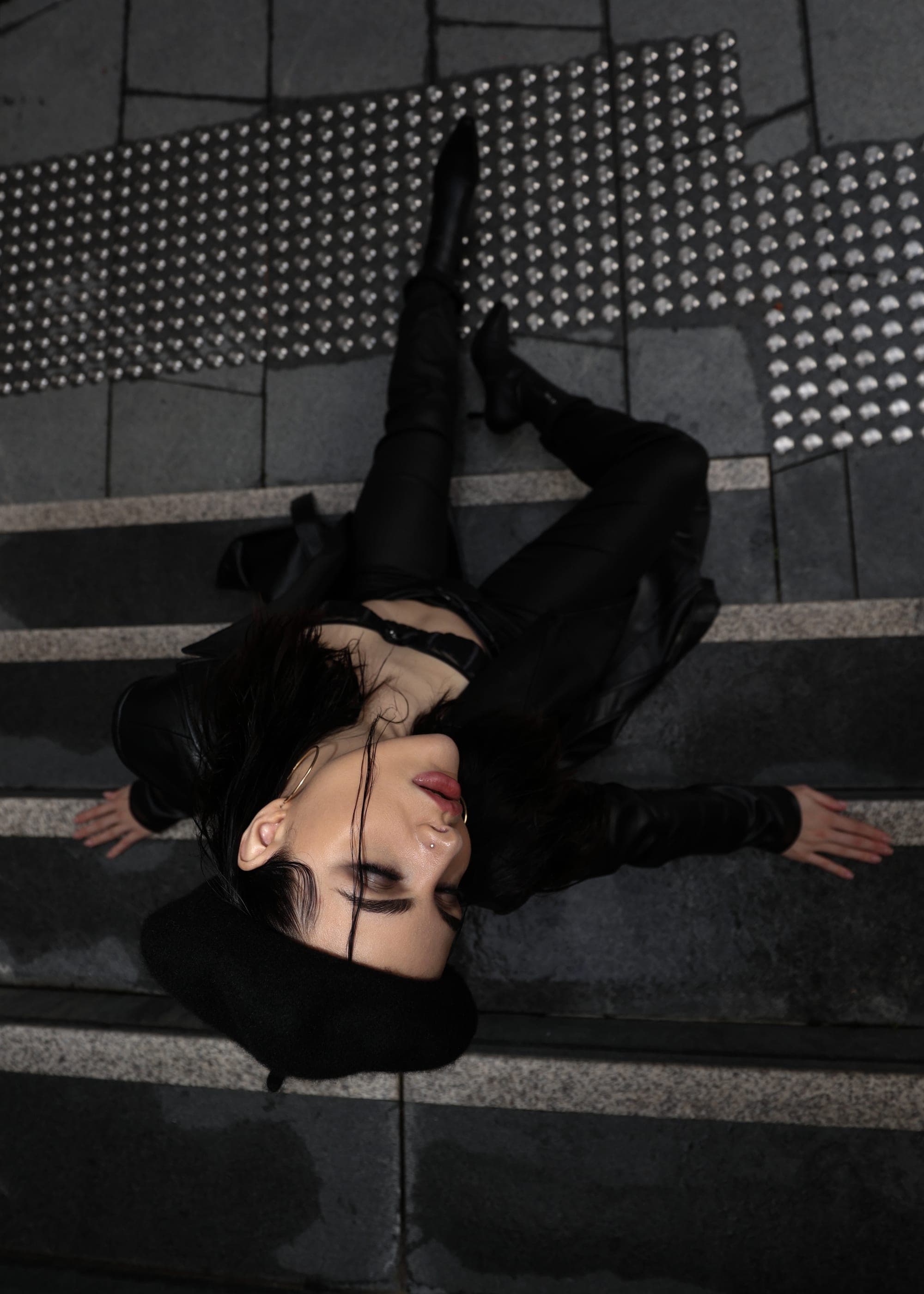 Model in a leather beret and jacket on textured stairs, overhead Sydney street fashion shot